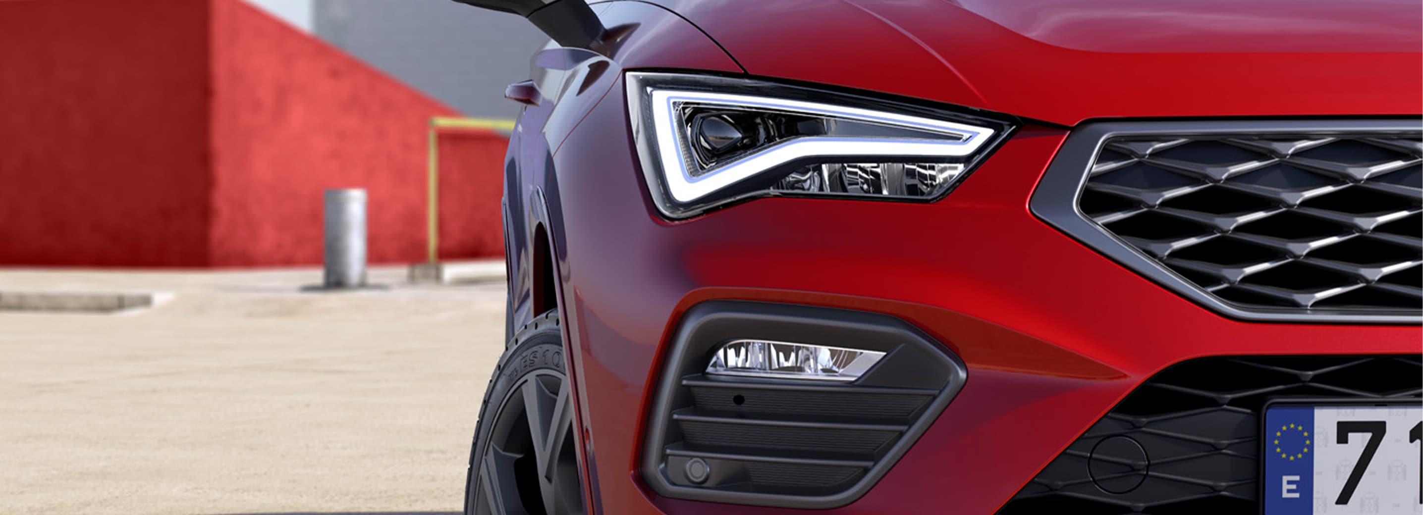 a person approaching to a red seat ateca parked in the street