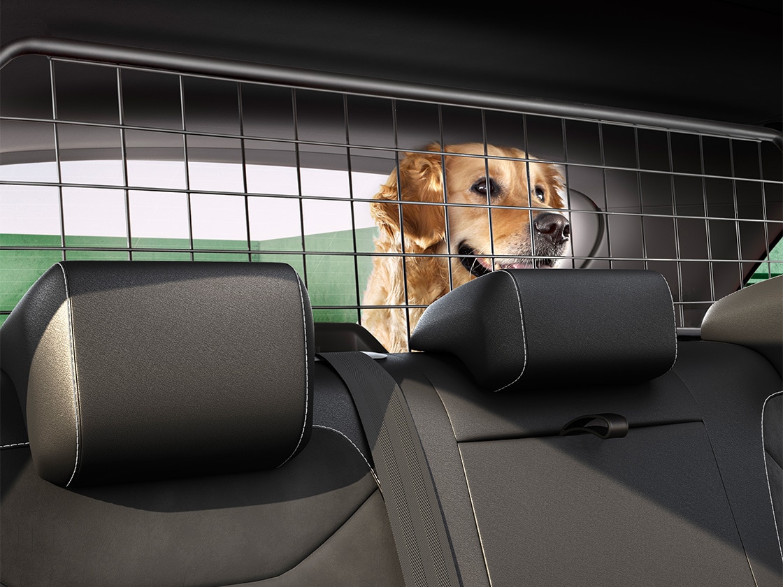 A dog behind the SEAT Ateca separation grille to show how it works.