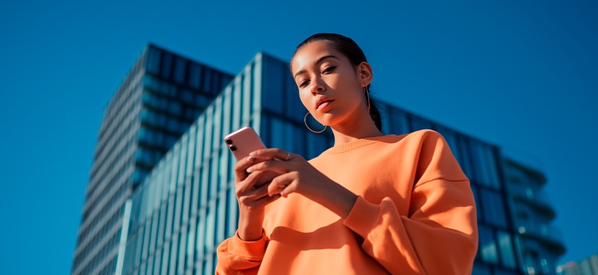 A person using their smartphone to show that you can download the manuals anytime, anywhere.