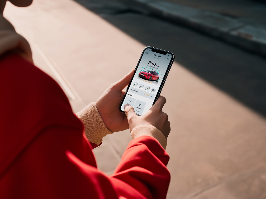 Person holding their smartphone using seat’s remote functions