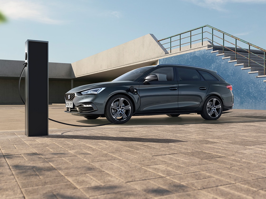 Hero angle of the SEAT Leon NF Sportstourer in an outdoor, sunny setting with stairs behind.