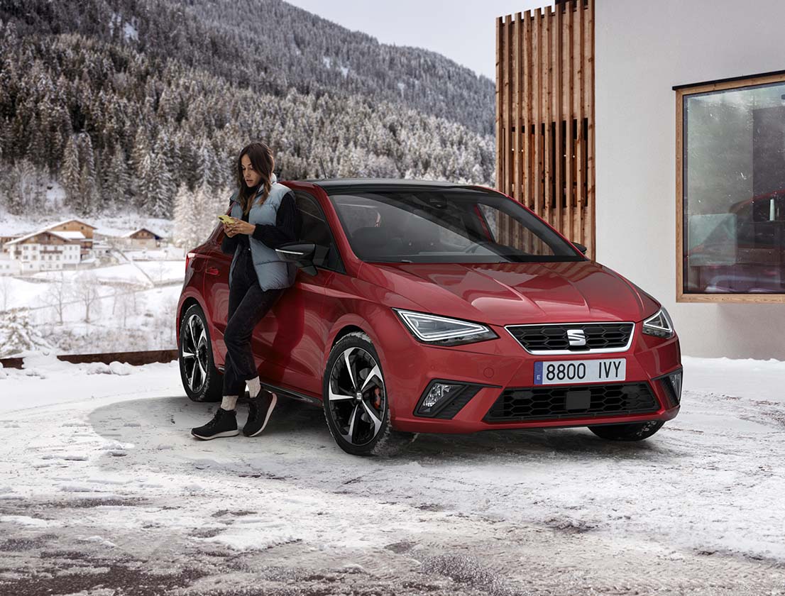 woman leaning on the seat ibiza desire red in the snow