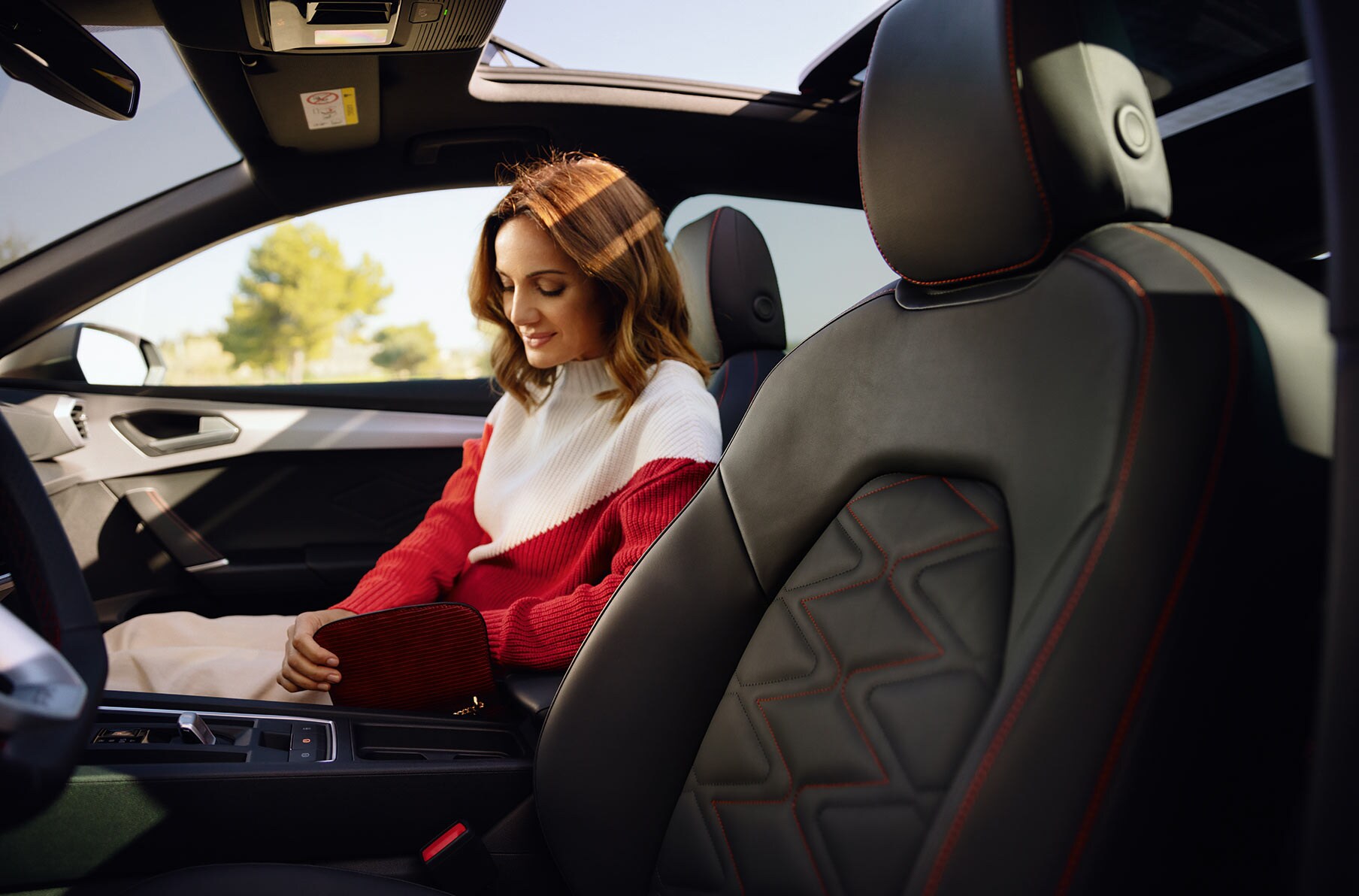 woman sitting in the passenger seat, enjoying the seat interior