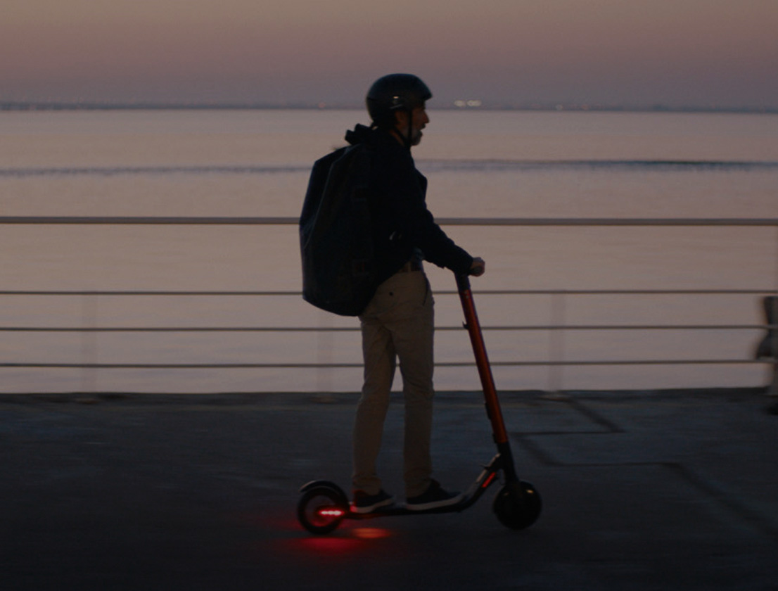 Person riding the SEAT MÓ 25 electric scooter with long life LED lights 