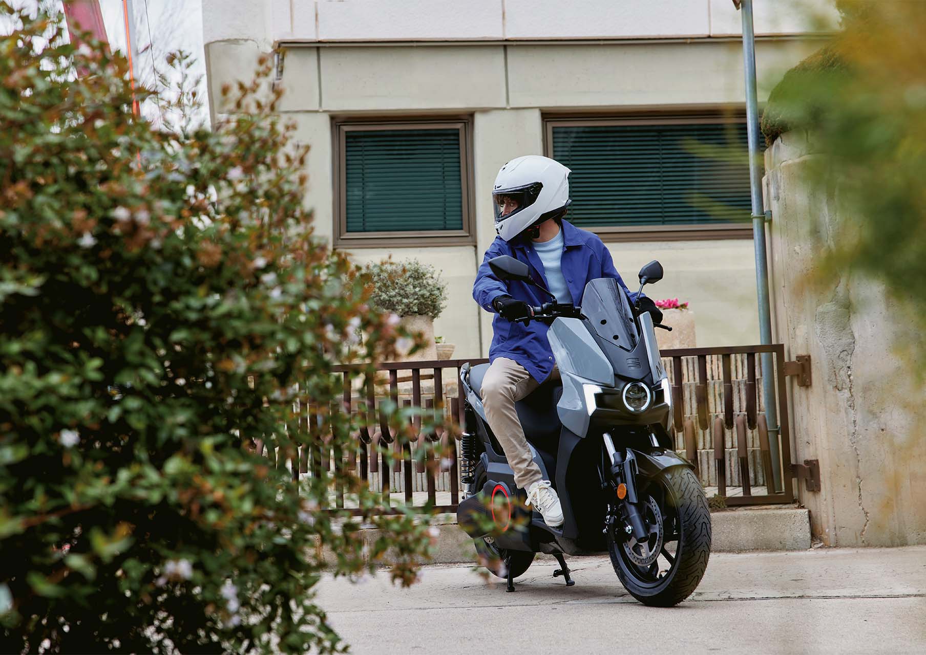 a man riding a SEAT MO 50 electric scooter