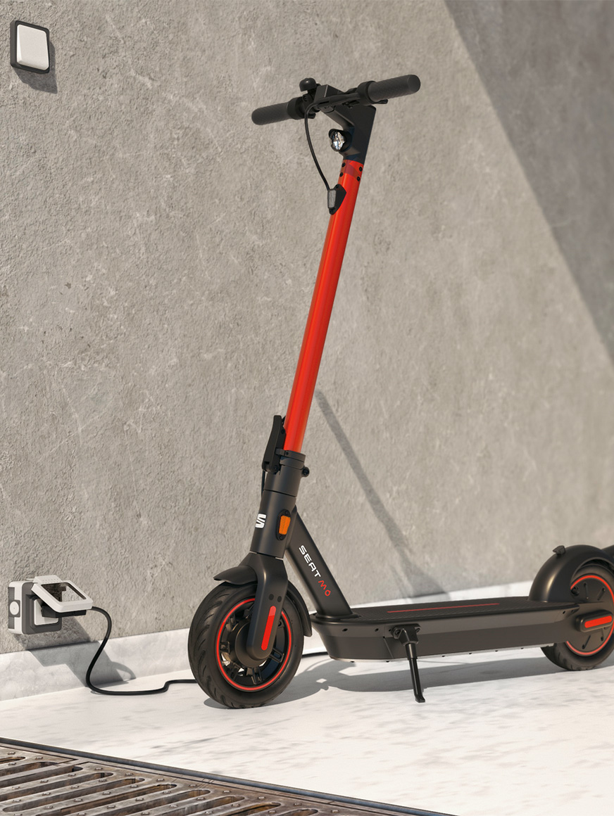 SEAT MO 65 electric scooter charging on a conventional plug