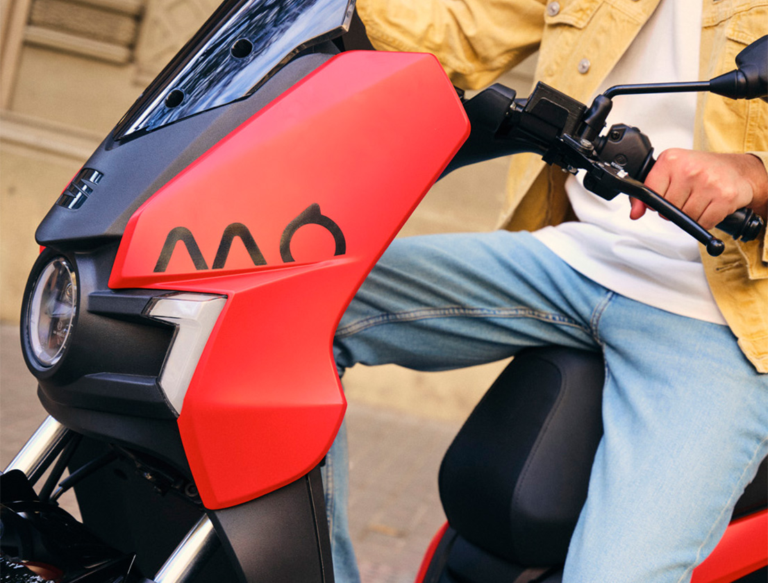 a man riding his SEAT MO 125 electric scooter