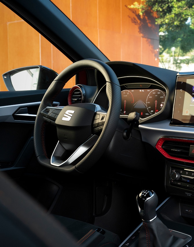 Interior view of SEAT Arona SUV showing dashboard, steering wheel and infotainment screen