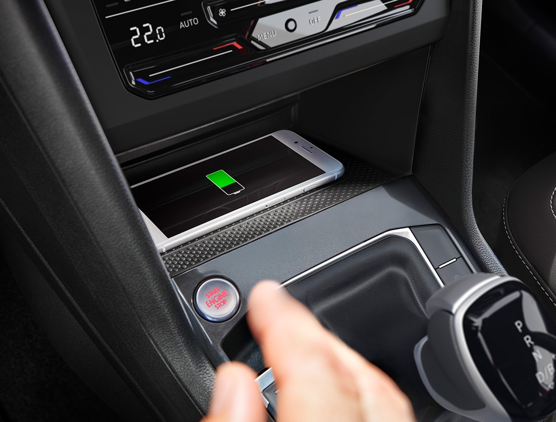 Driver charging his smartphone connected to a SEAT car