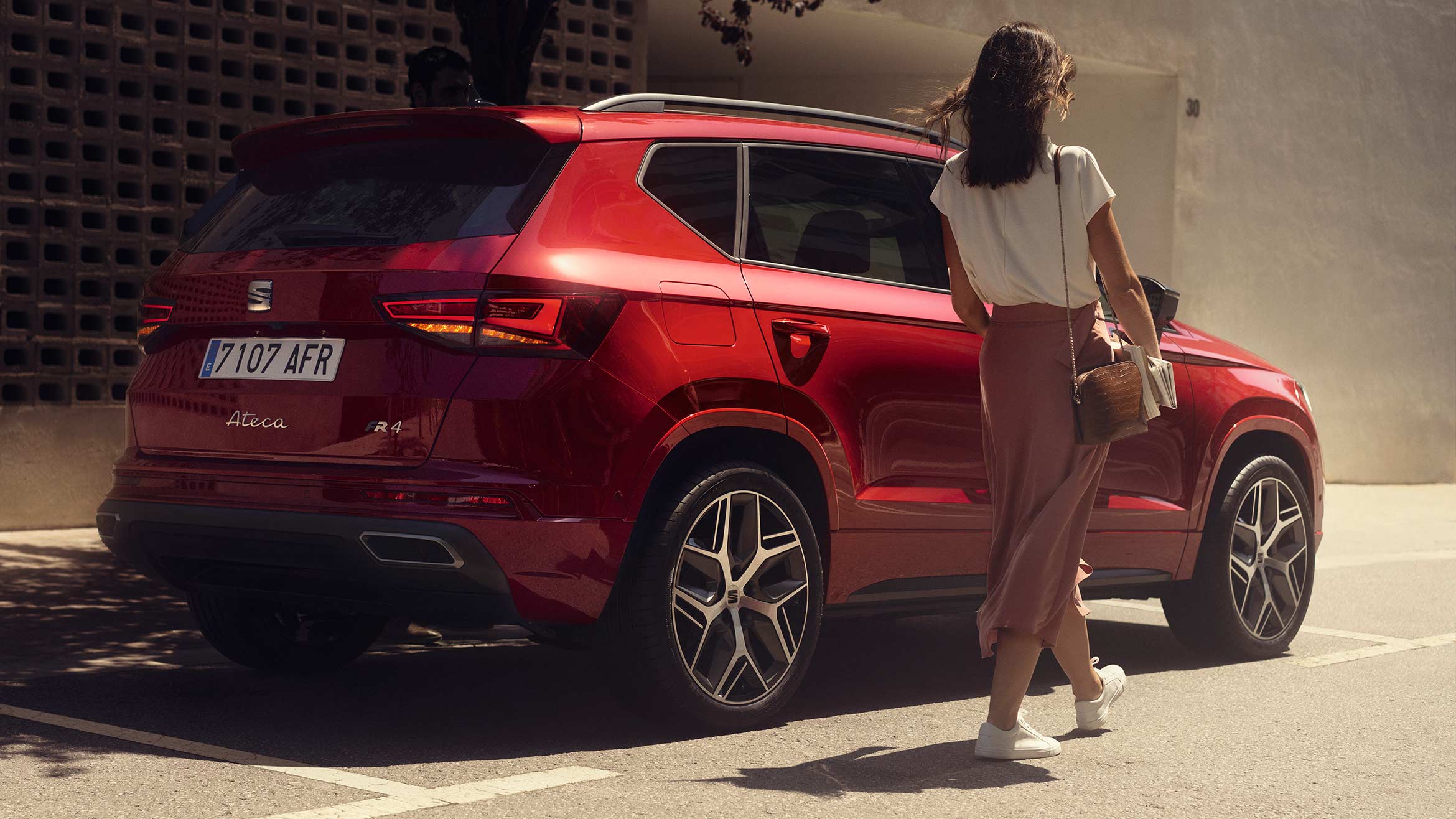 Woman near by the SEAT Ateca FR velvet red colour     