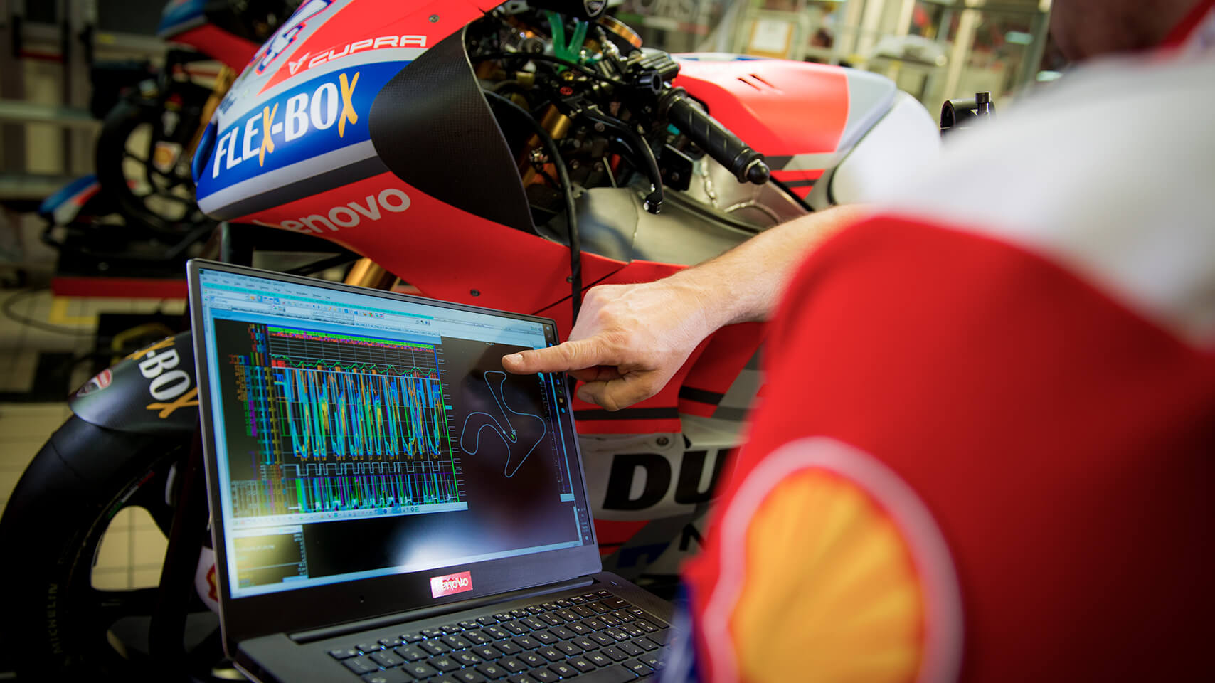 Ducati technology  with operator looking and pointing computer analysis 