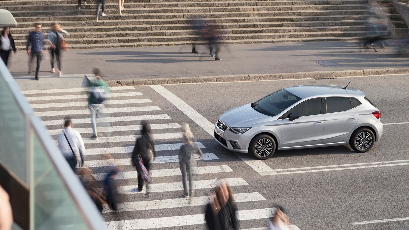 SEAT car stopped at street while people cross the road