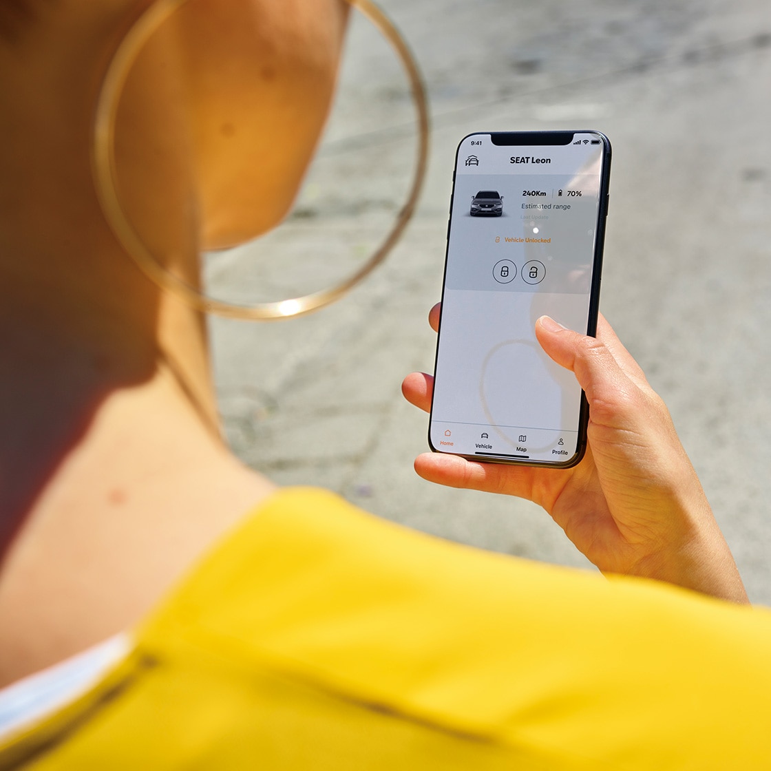 person using the my seat app on a smartphone, showcasing features for car management and connectivity.