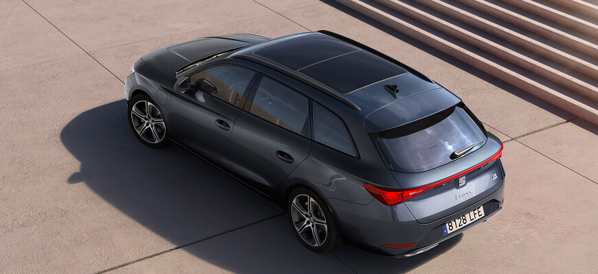 Eagle view of a Magnetic Tech Grey SEAT Leon Sportstourer e-HYBRID parked on a concrete surface.