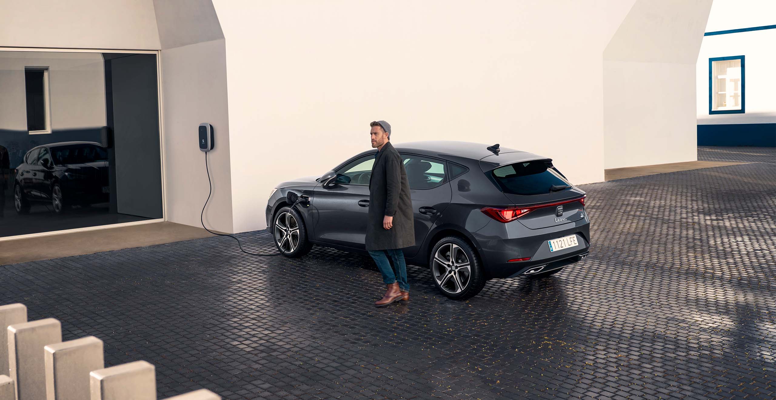 Man with new SEAT charge plug in at home