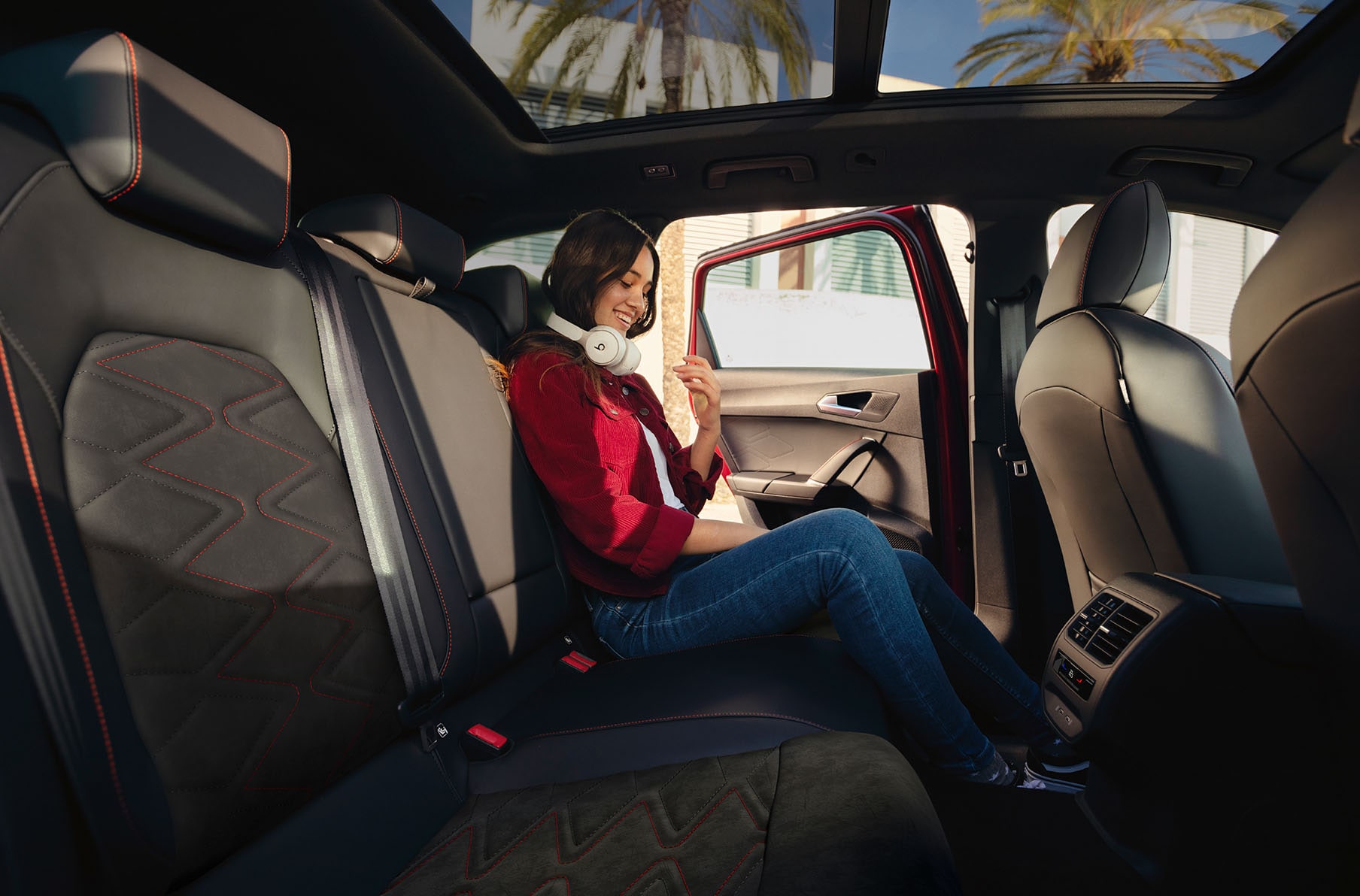 woman sitting in the seat leon dinamica microfiber sports seats.