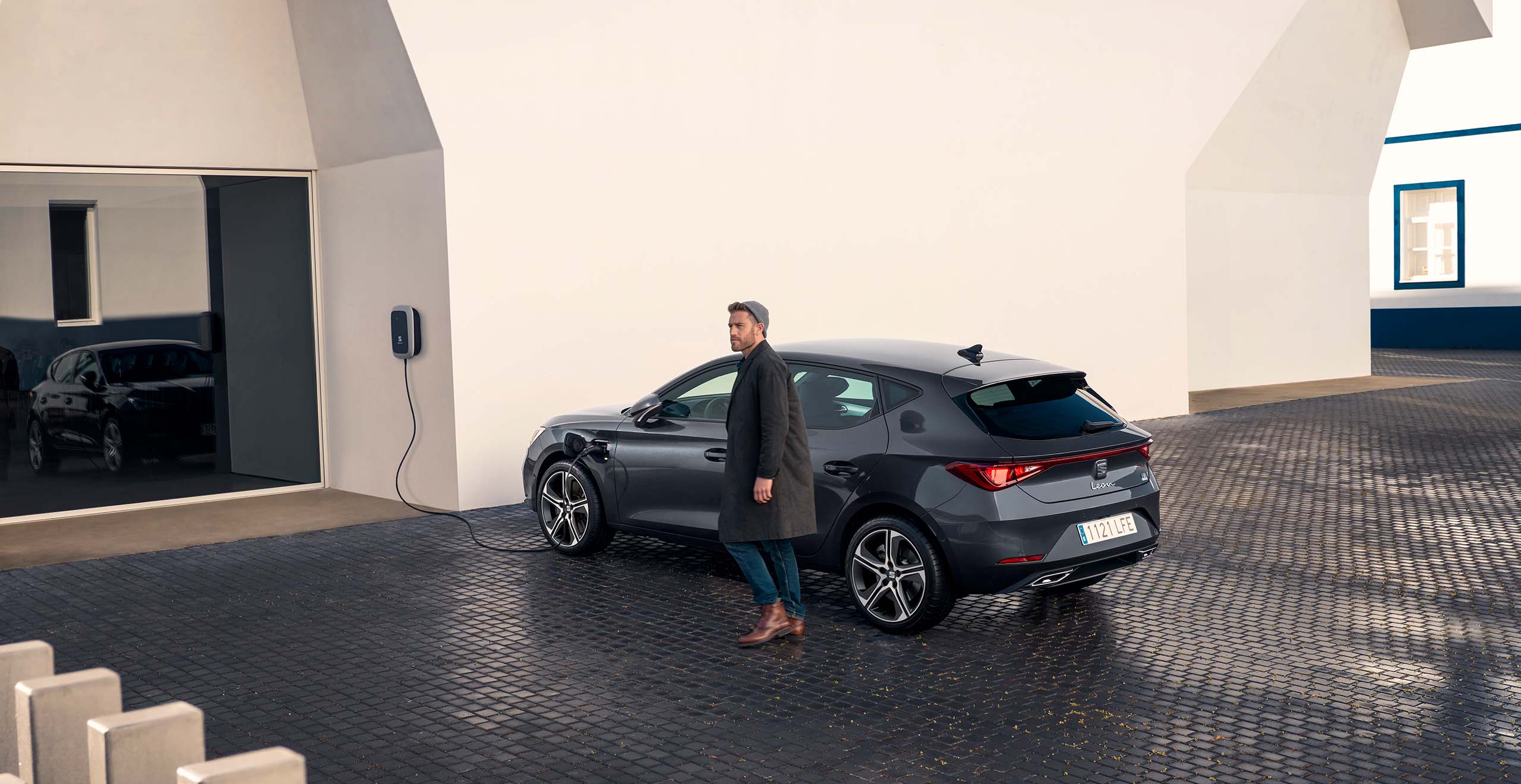 Man with new SEAT charge plug in at home