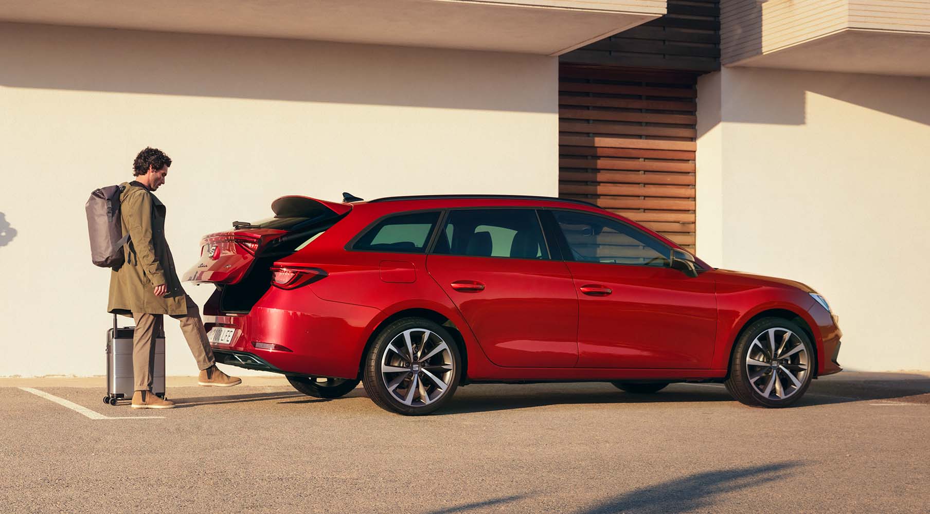 SEAT Leon Sportstourer parked at home with woman watching in a relaxed scene