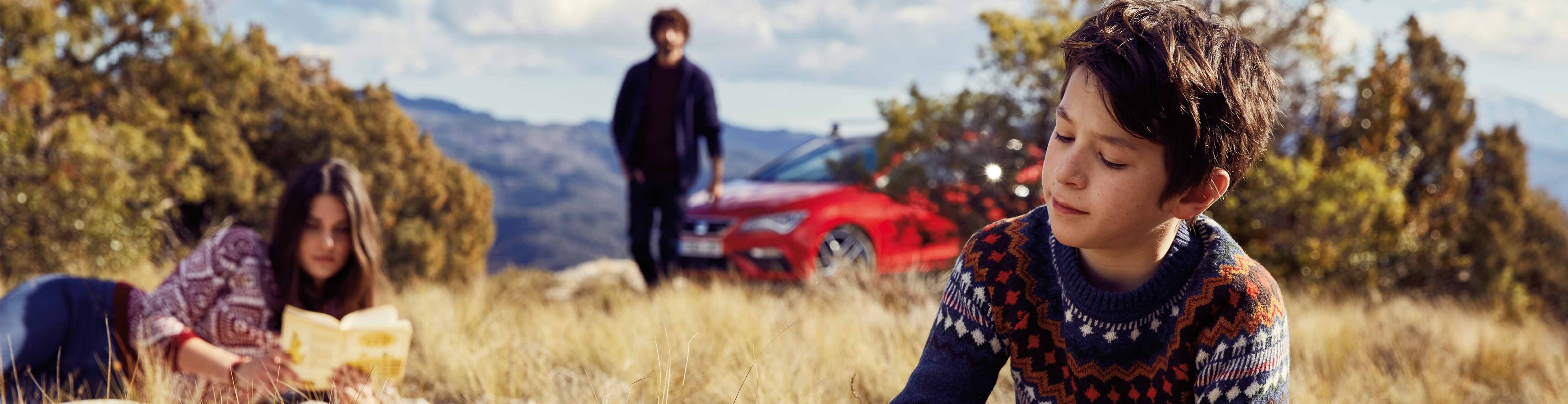 family-enjoying-a-picnic-while-a-seat-leon-is-parked 