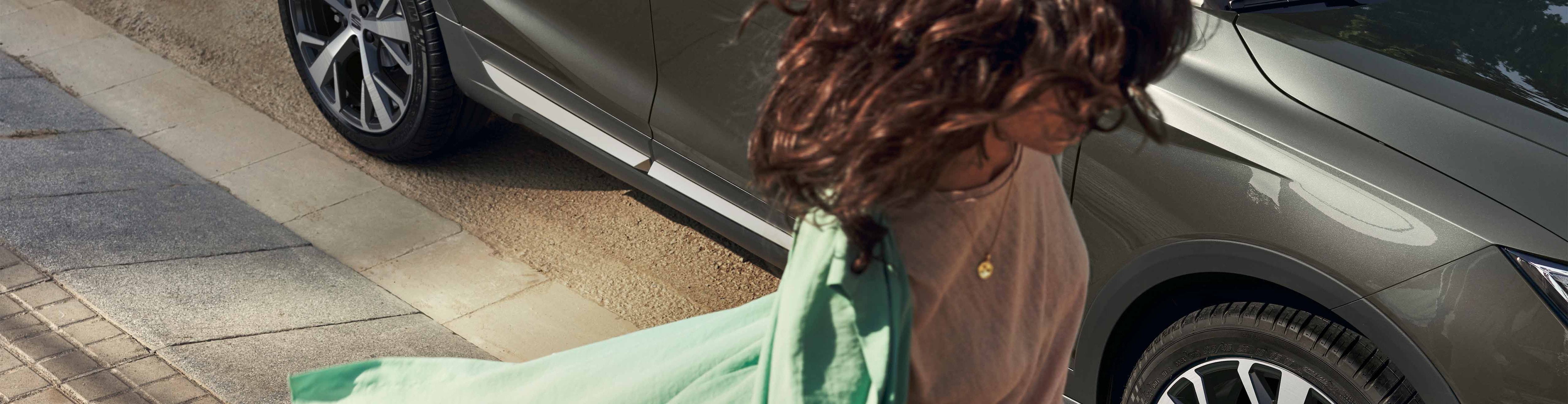 woman putting her coat next to a seat arona 