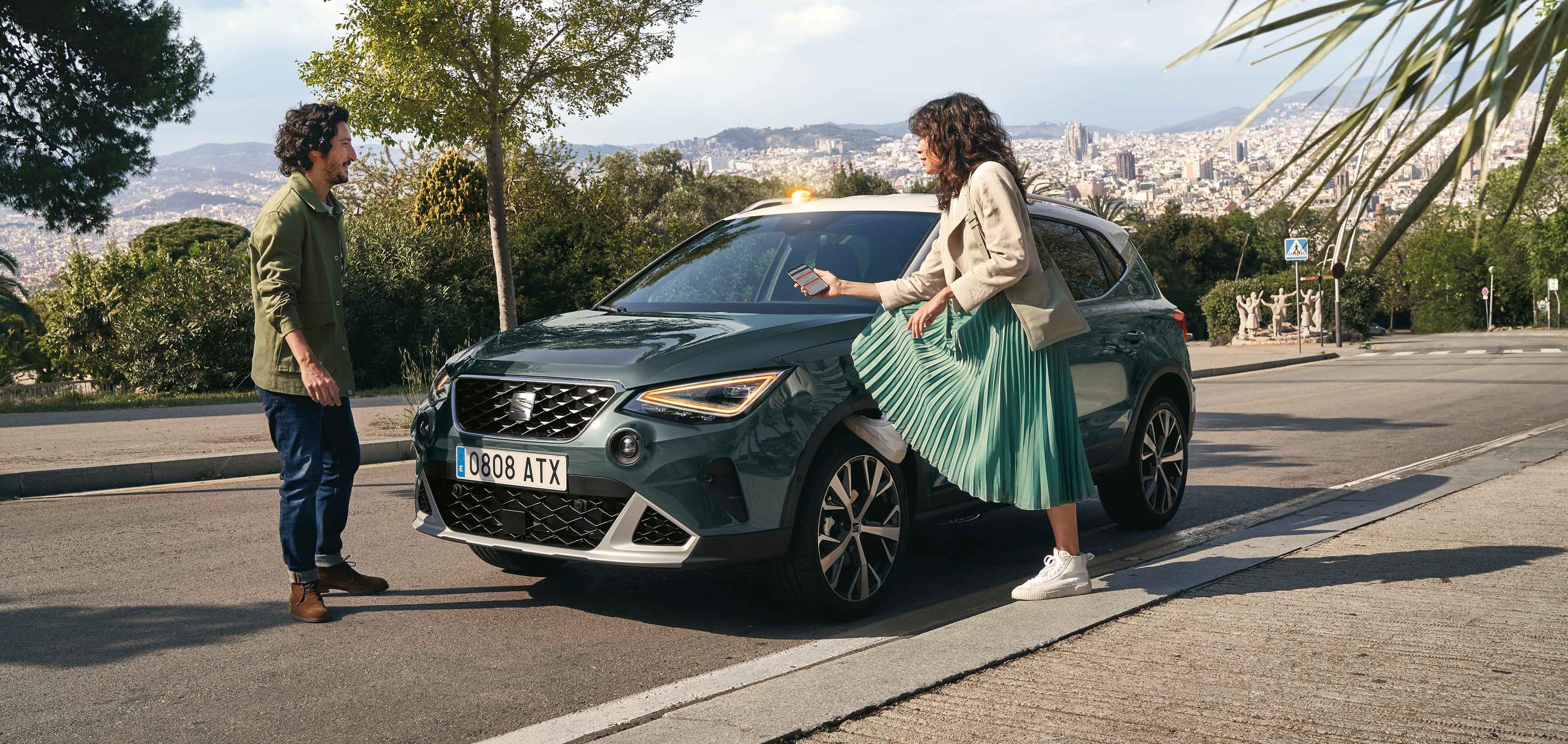 couple talking in front of the seat arona 