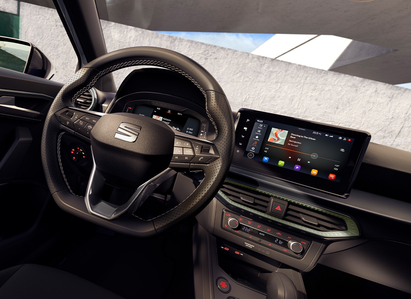 A view from the driver's seat of a SEAT Arona interior, showing the steering wheel with the SEAT logo, the digital driver's display, and the central infotainment screen.