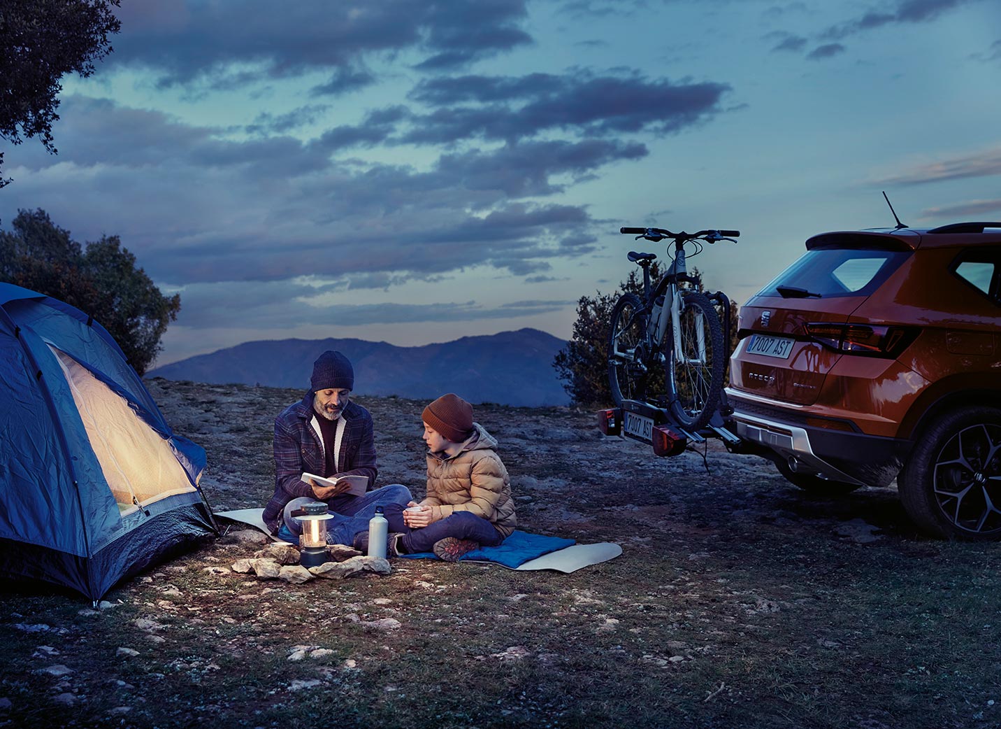 family-in-a-camping-with-car-behind