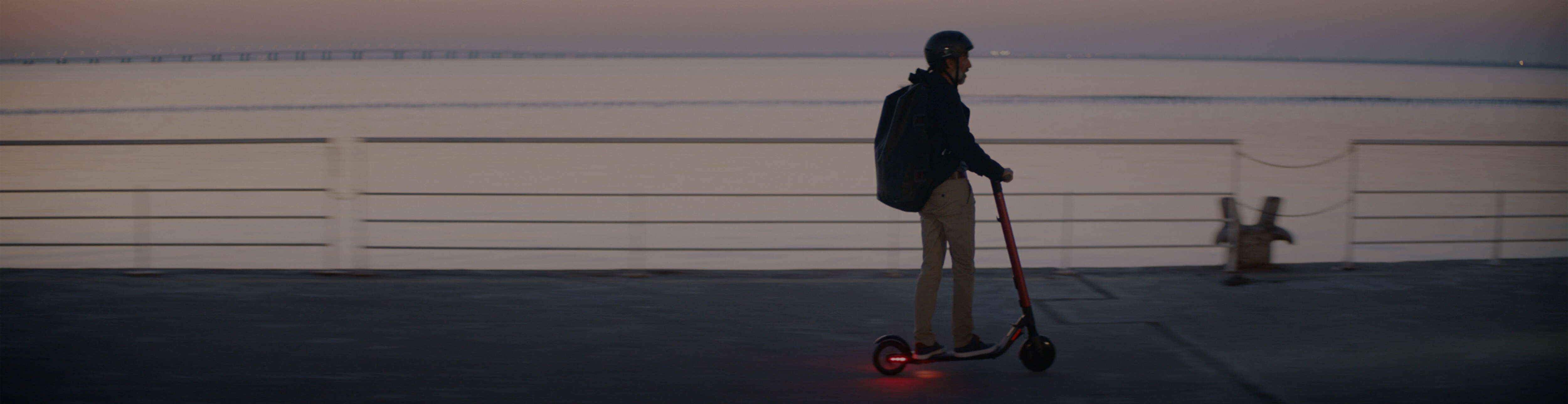 Man riding a SEAT MÓ 65 range electric scooter led lights 