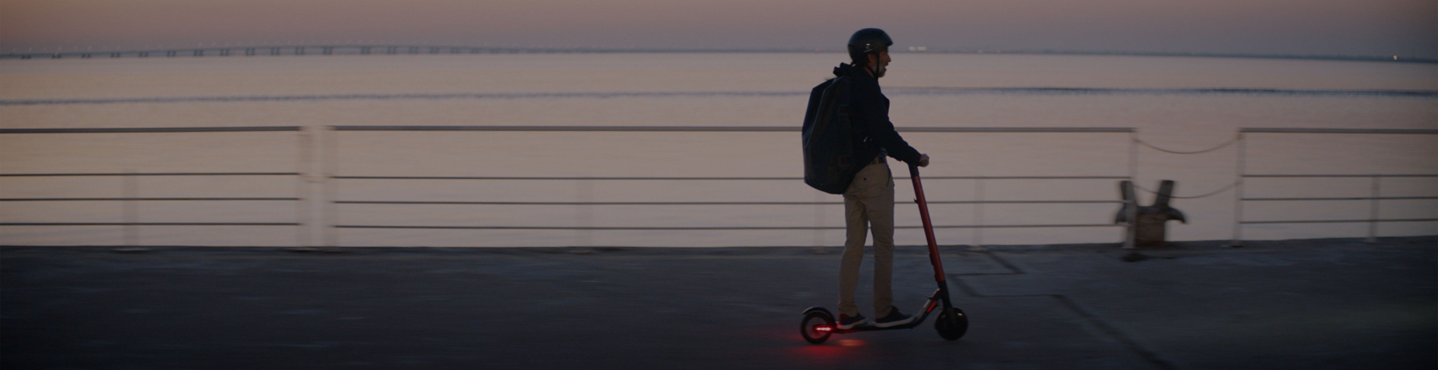 Man riding a SEAT MÓ 65 range electric scooter led lights 